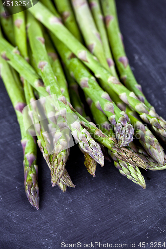 Image of Organic fresh raw garden asparagus closeup on black board backgr