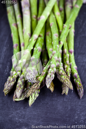 Image of Organic fresh raw garden asparagus closeup on black board backgr