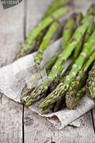 Image of Bunch of fresh raw garden asparagus closeup and linen napkin on 