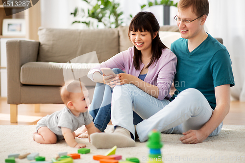 Image of happy family with baby boy at home