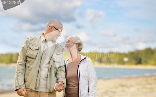 Image of happy senior couple over beach background