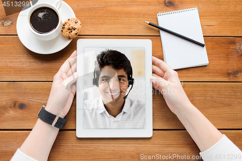 Image of close up of woman having video call on tablet pc