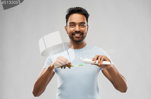 Image of indian man with toothbrush and toothpaste