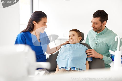 Image of female dentist with kid patient at dental clinic