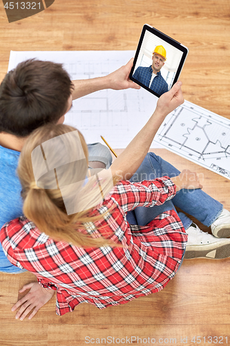 Image of couple having video call with builder