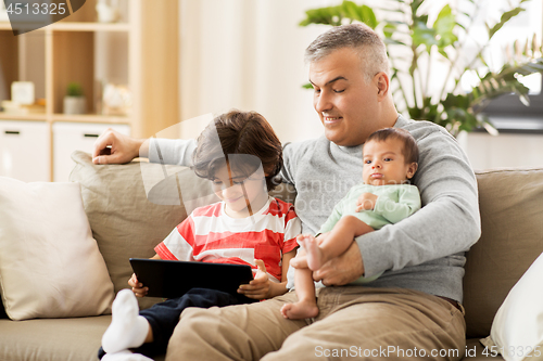 Image of happy father with preteen and baby son at home