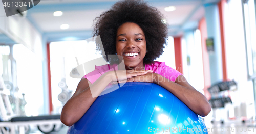 Image of portrait of young afro american woman in gym on workout break