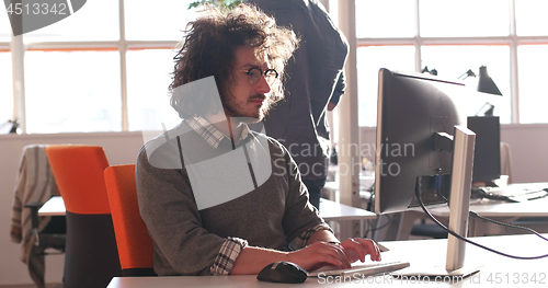 Image of businessman working using a computer in startup office