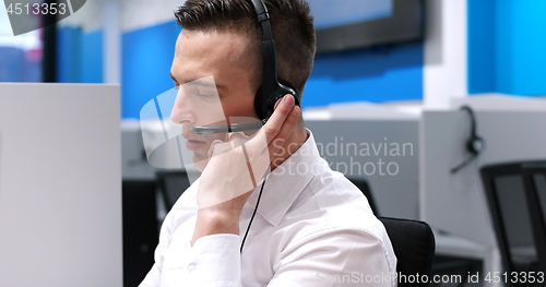 Image of male call centre operator doing his job