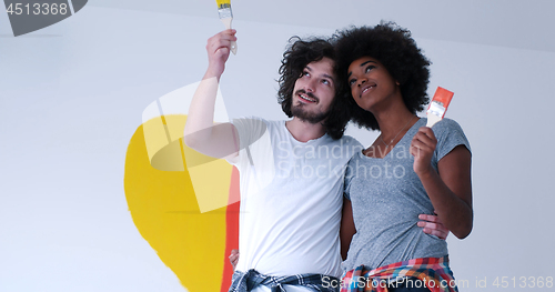 Image of couple with painted heart on wall