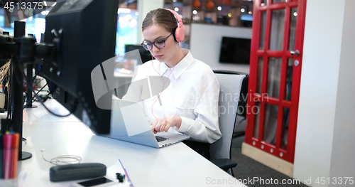 Image of businesswoman using a laptop in startup office