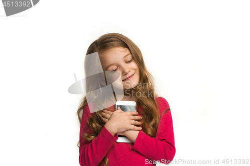 Image of The happy teen girl standing and smiling against white background.