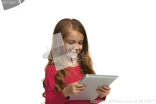 Image of Little funny girl with tablet on white background