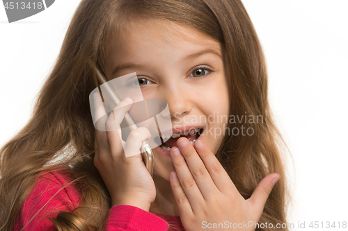 Image of The happy teen girl standing and smiling against white background.