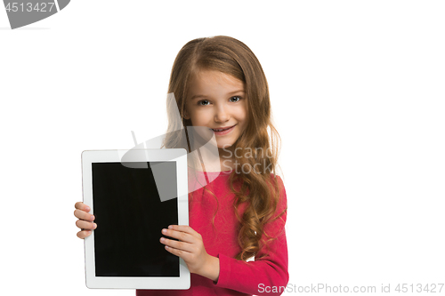 Image of Little funny girl with tablet on white background