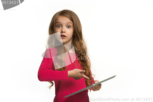 Image of Little funny girl with tablet on white background