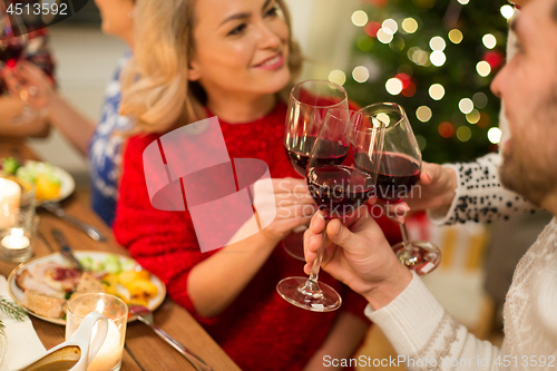 Image of close up of friends with wine celebrate christmas