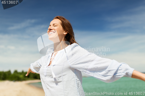 Image of happy smiling woman on summer beach