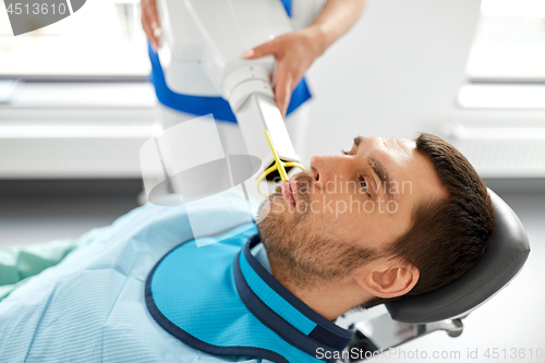 Image of dentist making dental x-ray of patient teeth