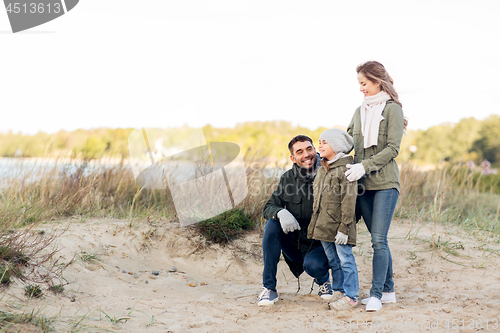 Image of happy family at autumn beach