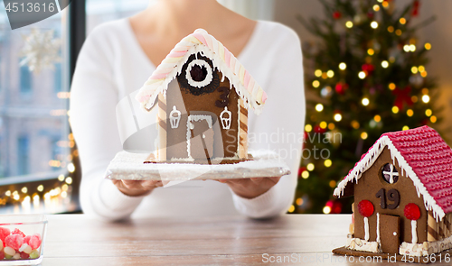 Image of close up of woman with christmas gingerbread house