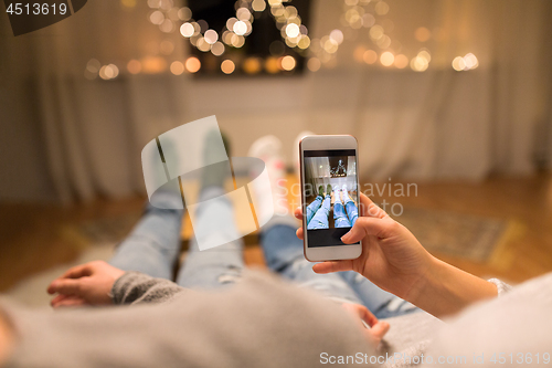 Image of close up of couple taking foot photo by smartphone