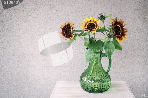 Image of Bouquet of sunflowers in a green vase