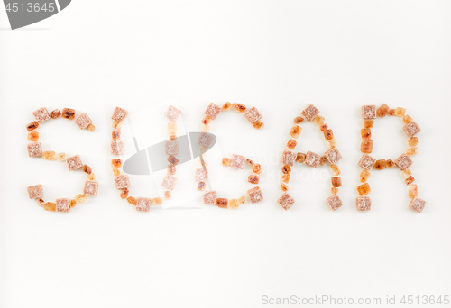 Image of SUGAR written with brown sugar pieces