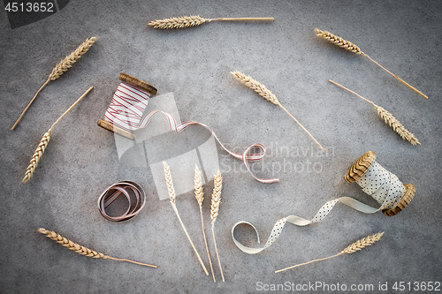 Image of Wheat ears and vintage ribbon bobbins