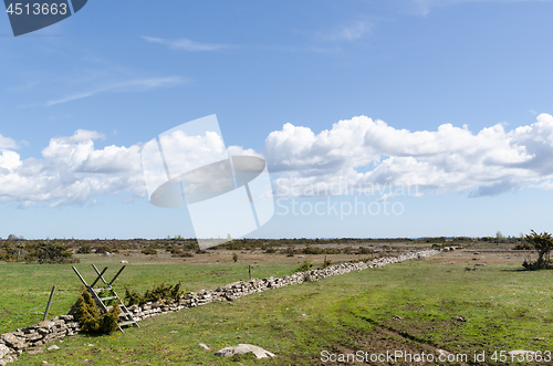 Image of Wooden stile by a dry stone wall in the great plain grassland Al