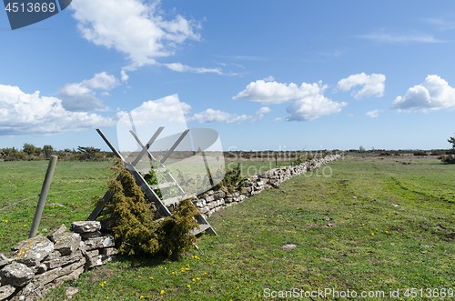 Image of Wooden stile by a dry stone wall in spring season at the great p