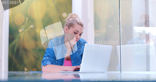 Image of young women using laptop computer on the floor