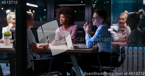Image of Multiethnic startup business team in night office