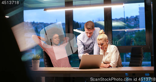 Image of Multiethnic startup business team in night office