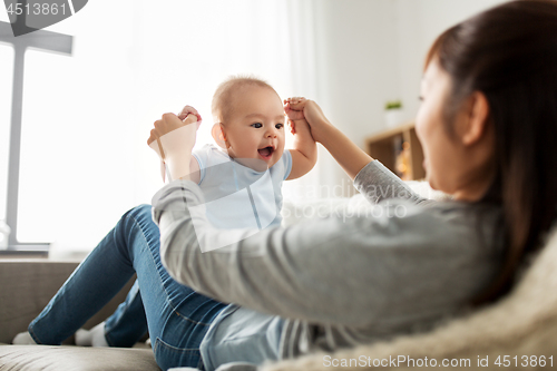 Image of happy mother with little baby son at home