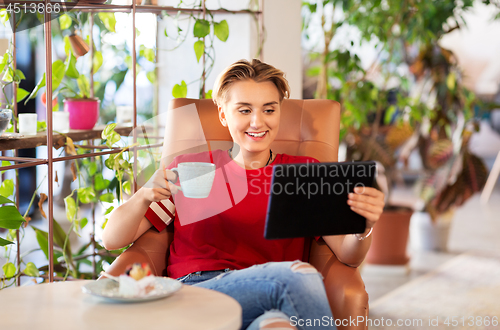 Image of happy woman with tablet pc at cafe or coffee shop