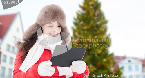 Image of woman with tablet pc over christmas tree