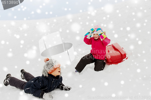 Image of happy little kids with sled down hill in winter