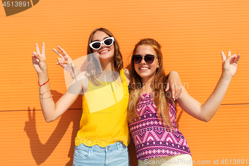 Image of smiling teenage girls showing peace in summer