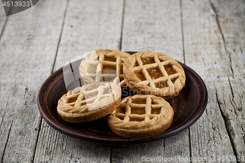 Image of Fresh baked crostata with marmalade or apricot jam filling on br