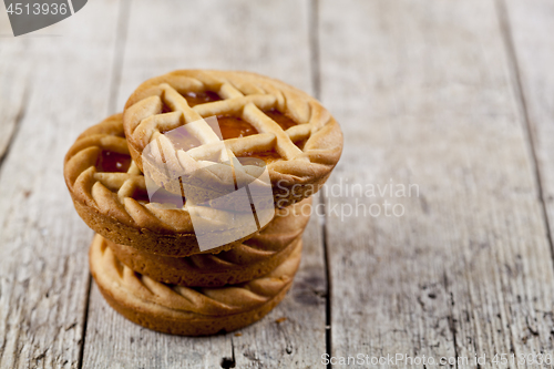 Image of Fresh baked tarts with marmalade or apricot jam filling on on ru