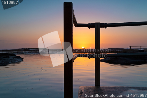 Image of Sunrise and rock pool reflections