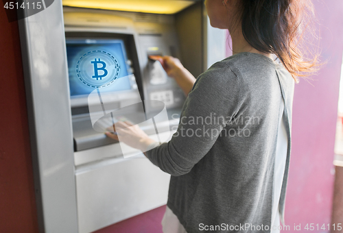 Image of close up of woman inserting card to atm machine