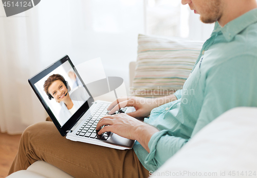 Image of man having video call with helpline operator