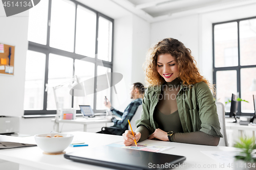 Image of creative woman working on user interface at office