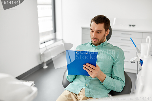 Image of patient filling application at dental clinic