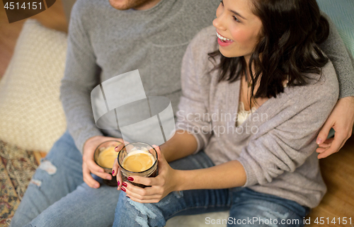 Image of close up of happy couple drinking coffee at home