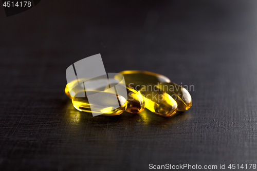 Image of Omega-3 oil capsules and vitamin for health care on black board 