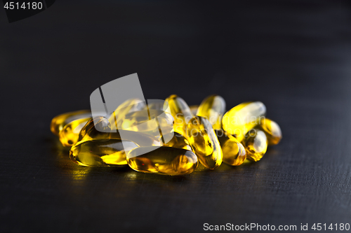 Image of Omega-3 oil capsules and vitamin for health care on black board 