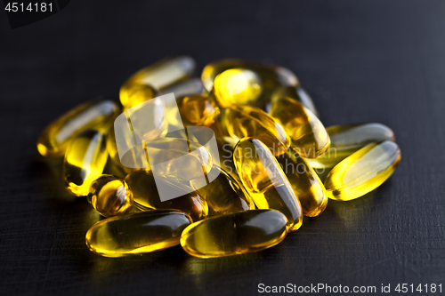 Image of Omega-3 oil capsules and vitamin for health care on black board 